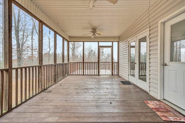 unfurnished sunroom with a wealth of natural light, ceiling fan, and wooden ceiling