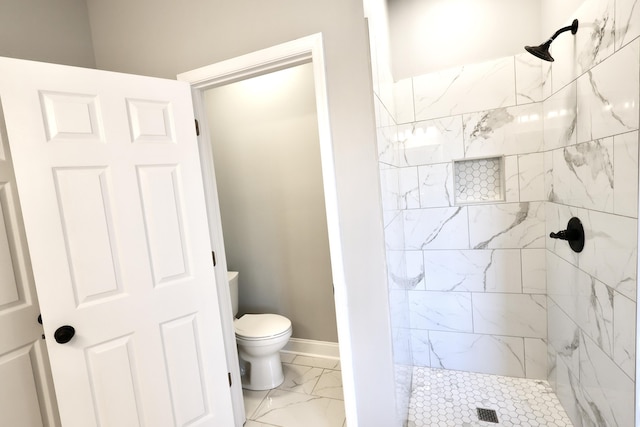 bathroom with tiled shower and toilet