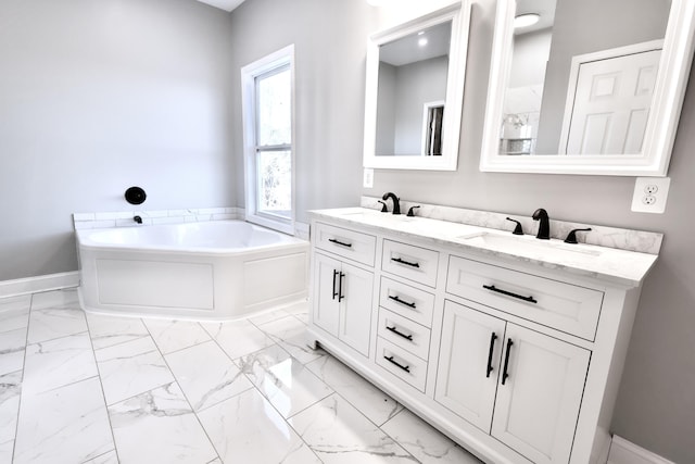 bathroom featuring vanity and a tub