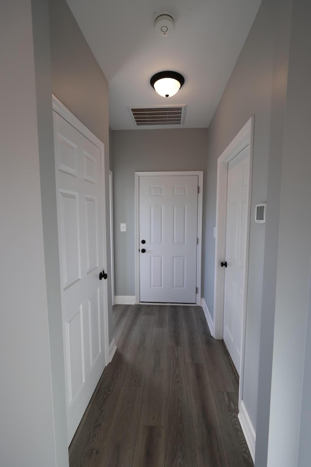 corridor featuring dark hardwood / wood-style floors