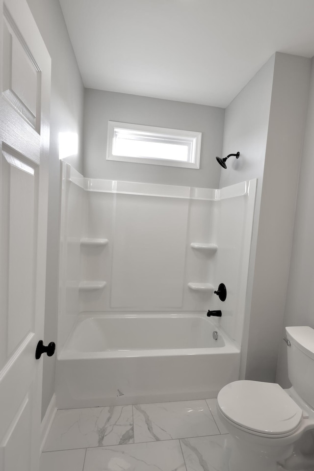 bathroom featuring shower / tub combination and toilet