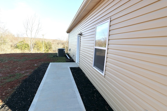 view of property exterior featuring a patio and central AC unit