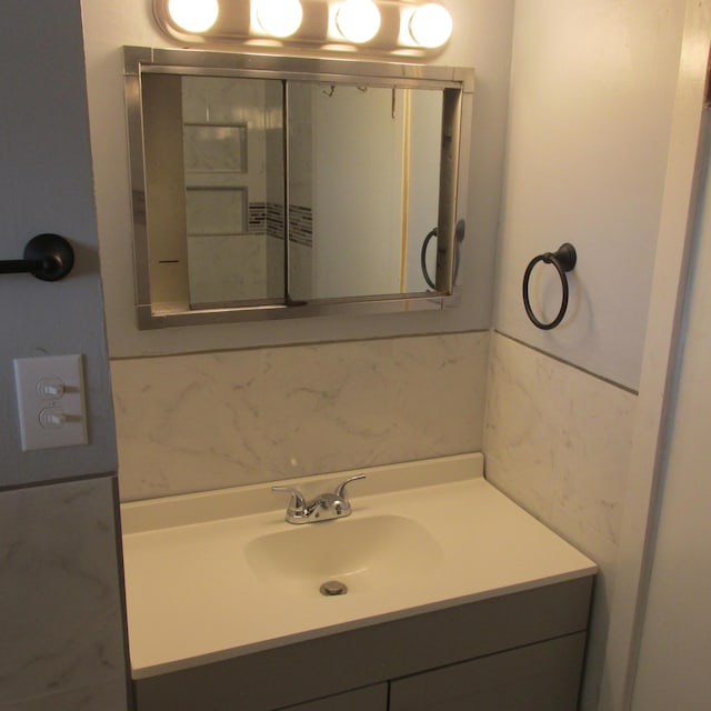 bathroom with vanity and backsplash