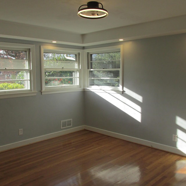 empty room with dark wood-type flooring