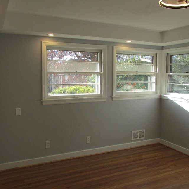 unfurnished room featuring dark hardwood / wood-style floors