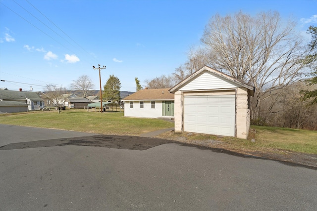 ranch-style home with a garage and a front lawn