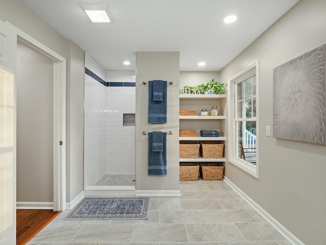 bathroom with hardwood / wood-style floors and tiled shower