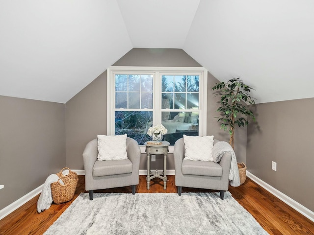 living area featuring hardwood / wood-style floors and vaulted ceiling