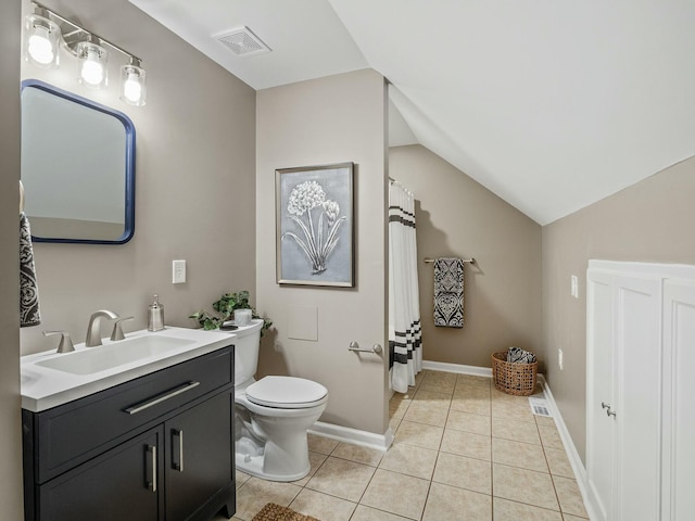 bathroom featuring tile patterned flooring, vanity, toilet, and lofted ceiling