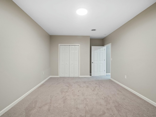 unfurnished bedroom with carpet floors and a closet