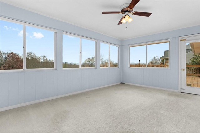 unfurnished sunroom featuring a ceiling fan