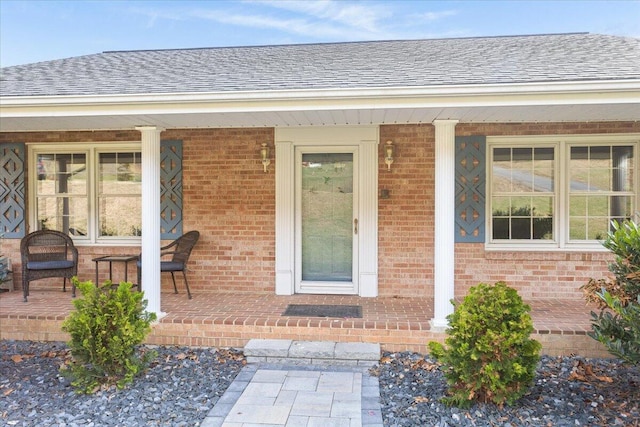 view of exterior entry featuring covered porch