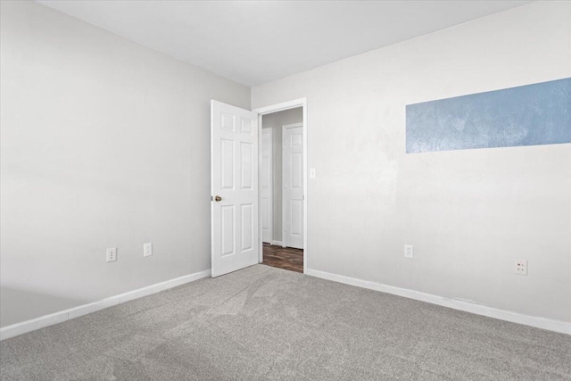 unfurnished bedroom with carpet flooring and baseboards