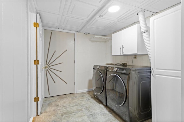 washroom with cabinet space and independent washer and dryer