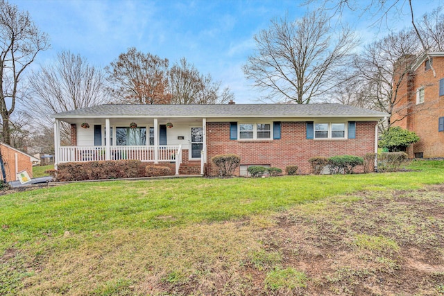 ranch-style home with covered porch and a front yard