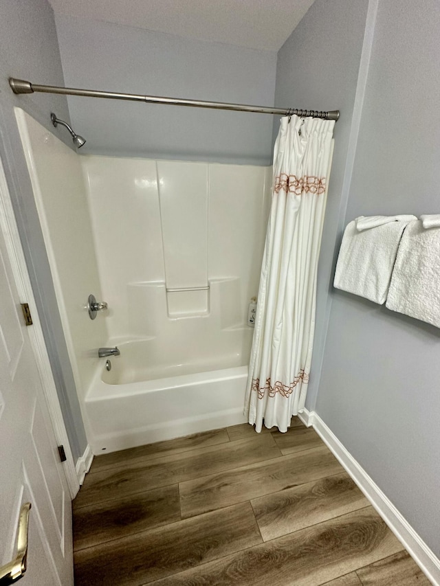 bathroom featuring shower / bath combination with curtain and wood-type flooring