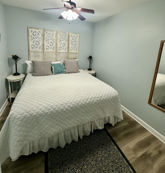 bedroom with ceiling fan and dark wood-type flooring