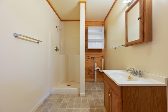 full bath with a stall shower, vanity, and crown molding