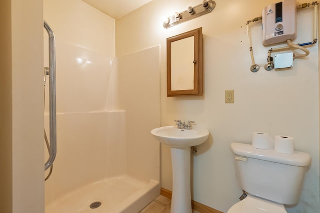 full bath featuring water heater, a shower stall, toilet, and a sink