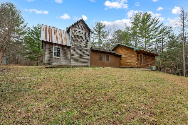 back of house featuring a yard, central AC unit, and crawl space