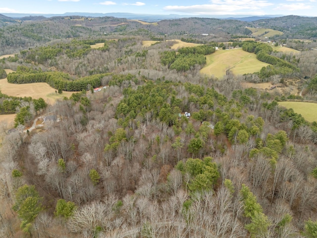 aerial view featuring a forest view and a mountain view