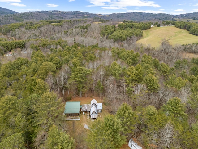 drone / aerial view featuring a view of trees and a mountain view