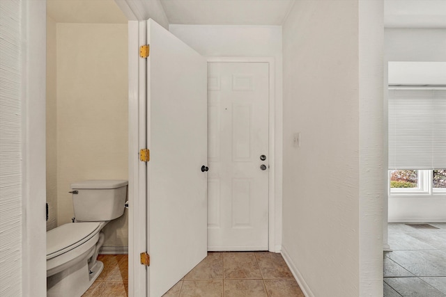 bathroom featuring tile patterned flooring and toilet