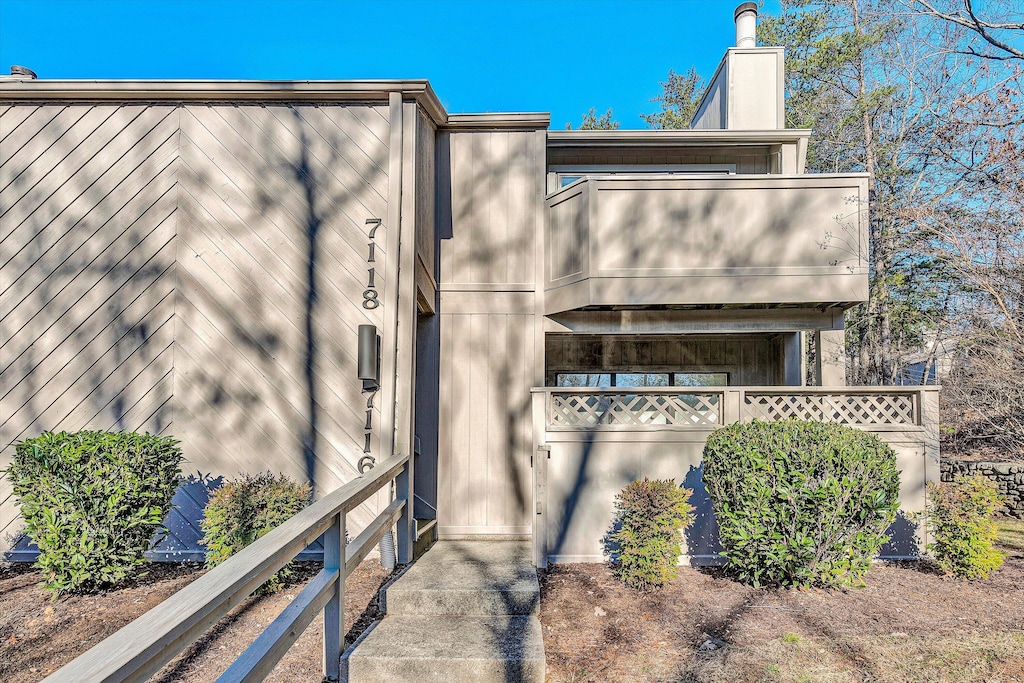 view of side of property featuring a balcony