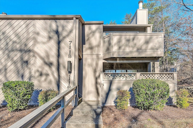 view of side of property featuring a balcony