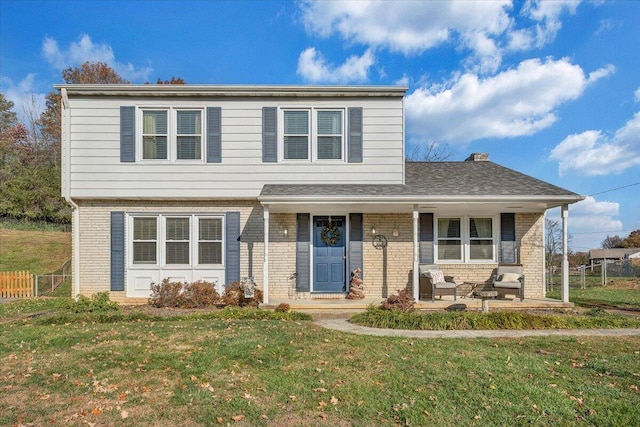 view of property with a porch and a front yard