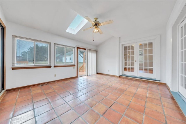 unfurnished sunroom with a ceiling fan, lofted ceiling with skylight, and french doors