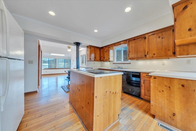 kitchen with crown molding, dishwasher, a center island, and freestanding refrigerator