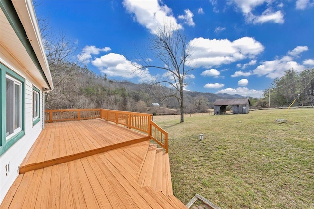 deck with a lawn and a mountain view