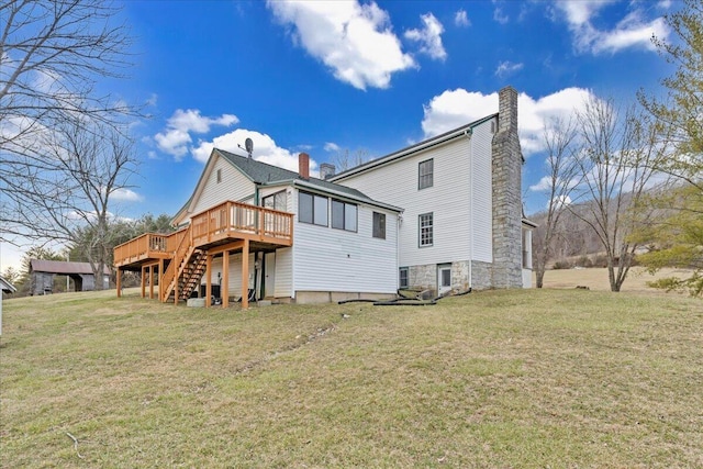 rear view of house featuring a deck, stairway, a yard, and a chimney