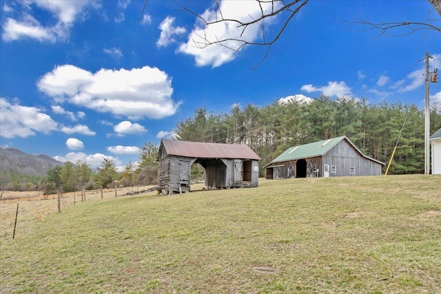 view of yard featuring a barn and an outdoor structure