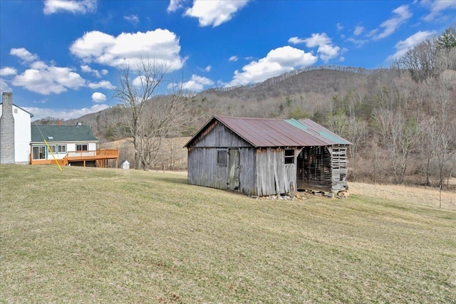 exterior space featuring an outbuilding and a deck with mountain view