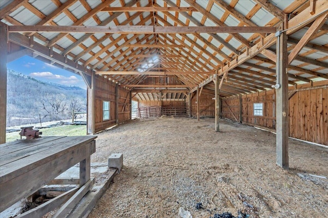 misc room featuring lofted ceiling, plenty of natural light, and a mountain view