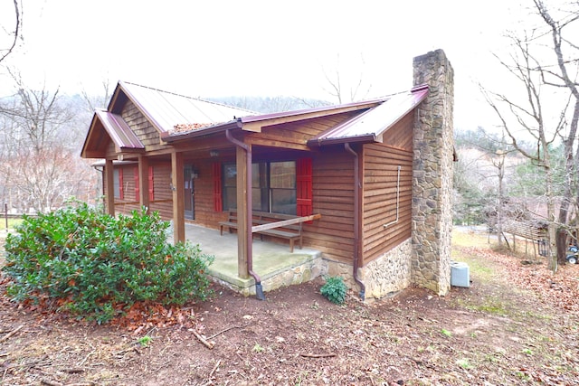 view of side of property with a porch