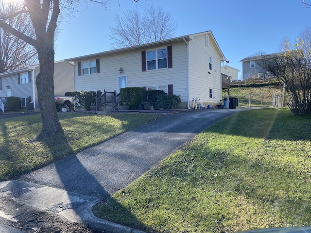 split foyer home with a front lawn