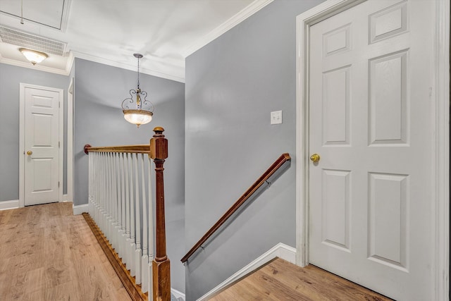 stairway with hardwood / wood-style flooring and ornamental molding