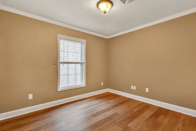 spare room featuring hardwood / wood-style floors and crown molding