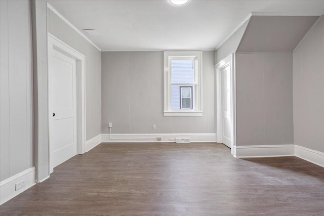 additional living space with dark wood-type flooring