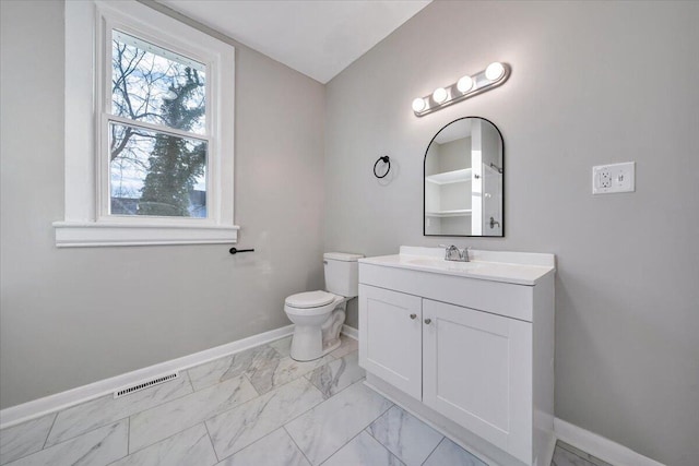 bathroom featuring toilet and vanity