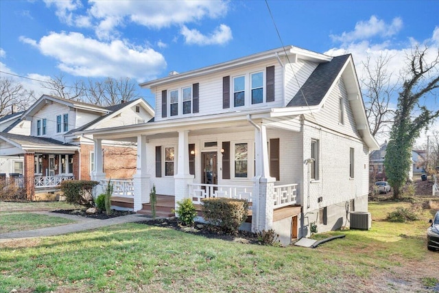 view of front of home featuring a front yard, covered porch, and central AC unit