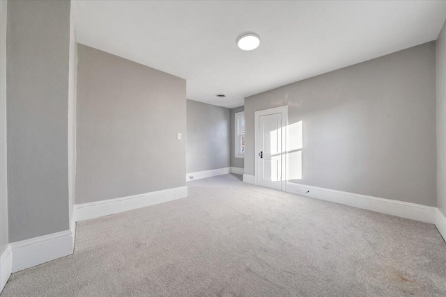 unfurnished room with light carpet