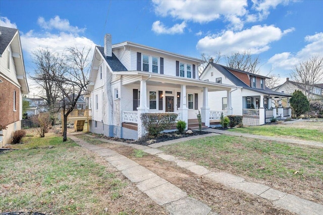 view of front of home with covered porch and a front lawn