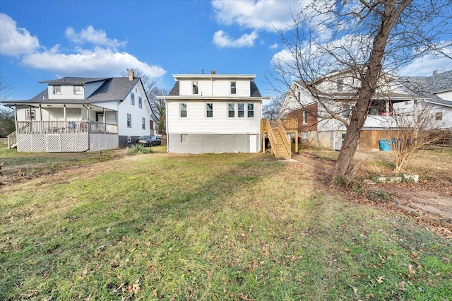 back of house with a lawn and a porch