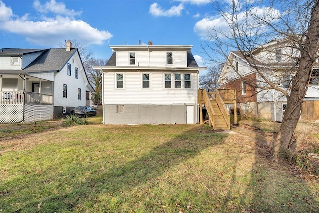 back of house featuring a lawn