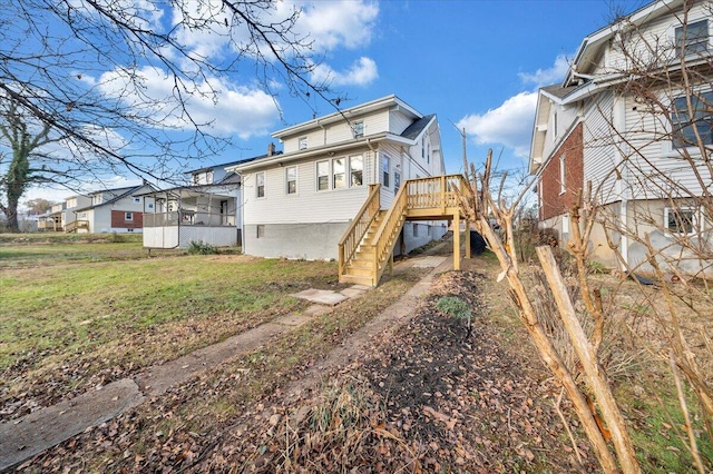 back of house featuring a deck and a yard