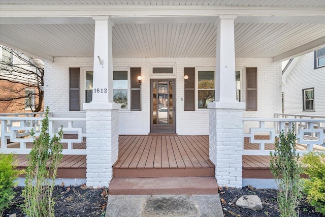 view of exterior entry featuring a porch